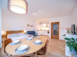 a living room with a table and a bed at Apartmán Ve středu dění in Poděbrady