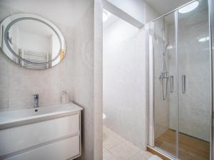 a bathroom with a shower and a sink and a mirror at Apartmán Ve středu dění in Poděbrady