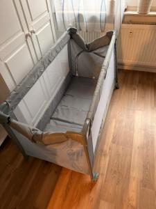 a bed frame in a room with a wooden floor at FeWo Weserblick in Brevörde