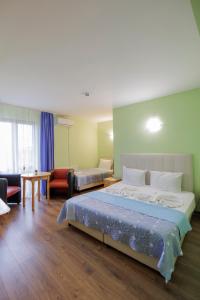 ein Hotelzimmer mit Bett und Wohnzimmer in der Unterkunft Trafi Em in Sofia