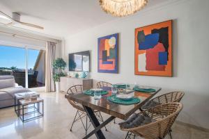 a living room with a table and chairs and a couch at NEW Duplex Penthouse, Spectacular Ocean View in Manilva