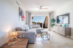 a living room with a couch and a table at NEW Duplex Penthouse, Spectacular Ocean View in Manilva +74 photos