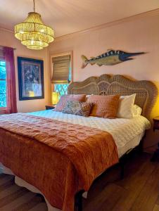 a bedroom with a bed with a fish on the wall at Creekside Paradise in Tybee Island