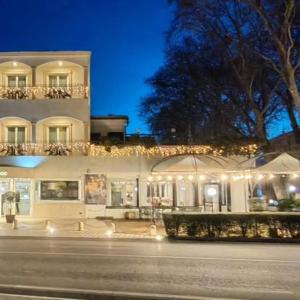 a large building with lights in front of it at Platani Hotel in Bolsena