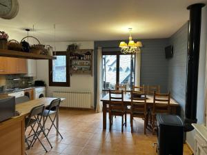 a kitchen and dining room with a table and chairs at Chalet Hoz de Jaca in Hoz de Jaca