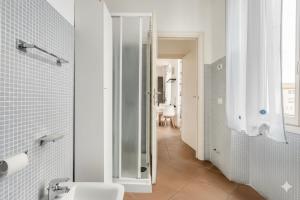 a bathroom with a toilet and a walk in shower at Moderno appartamento a 2 passi dal centro in Brescia