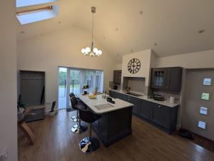 a kitchen with a island in the middle of a room at Allensmore House Gower in Swansea