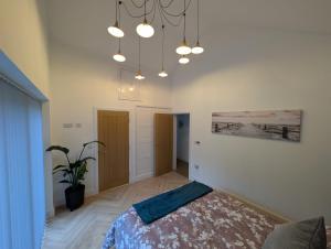 a bedroom with a bed and a painting on the wall at Allensmore House Gower in Swansea
