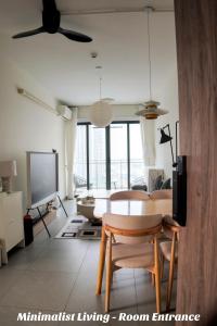a living room with a table and a tv at Minimalist Living , One bedroom in Phnom Penh