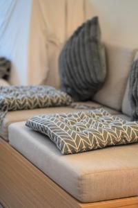 a couch with two pillows on top of it at Minimalist Living , One bedroom in Phnom Penh +47 photos