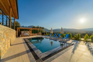a villa with a swimming pool and chairs at Villa Aden in Fethiye