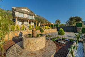 a house with a fountain in the middle of a yard at Villa Aden in Fethiye