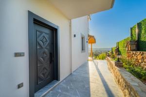 a door to a house with a pathway at Villa Aden in Fethiye +1 photo