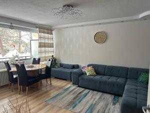 a living room with a blue couch and a table at Apartment Rita in Hannover