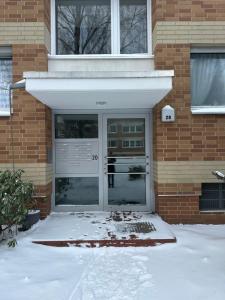 a front door of a house with snow on the ground at Apartment Rita in Hannover