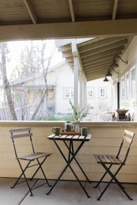 a porch with a table and two chairs and a window at Orchard Hill in Julian