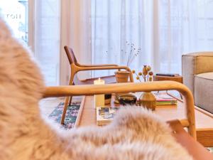 a cat sitting in a chair in a living room at freustil Hotel in Binz