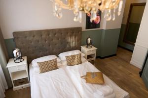 a bedroom with a large bed with two night stands at freustil Hotel in Binz +58 photos
