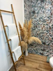 a bathroom with a ladder and towels and a plant at Las Casitas de Cullera Sol y Mar in Cullera +54 photos
