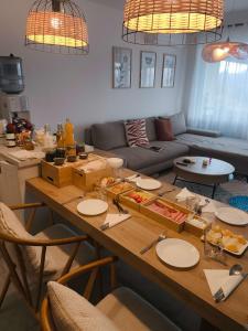 a living room with a table with food on it at EtyekZen in Etyek