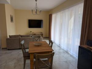 a living room with a table and a couch at Apartamenty Biwakowa 4B in Turawa