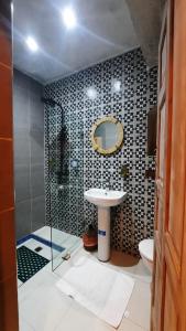 a bathroom with a sink and a toilet and a mirror at Hotel & Riad Celia in Marrakesh +92 photos