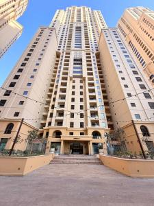 a large tall building with stairs in front of it at Spacious & classic Apartment in center of JBR in Dubai