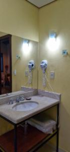 a bathroom with a sink and a mirror at CHALÉS DE SÃO JoSÉ in Tiradentes +153 photos