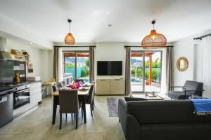 a kitchen and living room with a table and a couch at Villa Karya in Dalyan