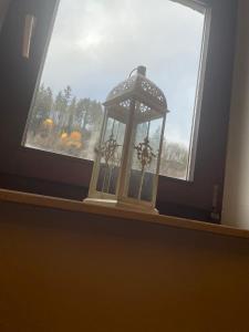 a window with a lantern sitting on a window sill at Gasthaus Liam 3 in Bendorf