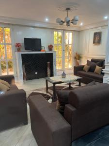a living room with a couch and a fireplace at MAISON Khadija Abibatou in Dakar