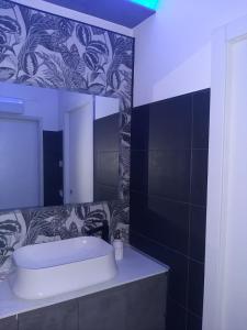 a bathroom with a sink and a mirror at LuX Apartments in Lugo