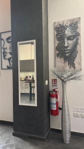 a fire extinguisher and a vase in a room at LuX Apartments in Lugo +27 photos
