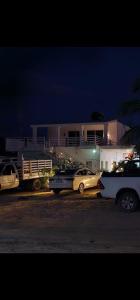 a group of cars parked in front of a house at Posada "Las Palmeras" in Dzilam de Bravo