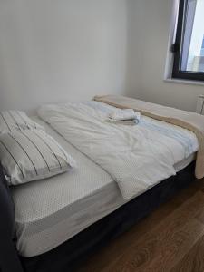 an unmade bed in a room with a window at Divna-Besplatan parking in Banja Luka