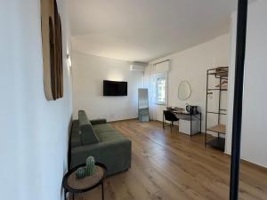 a living room with a couch and a table at Cinquantotto Cozy Rooms in Palermo