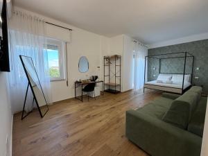 a living room with a couch and a bed at Cinquantotto Cozy Rooms in Palermo