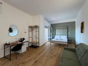 a living room with a couch and a bed at Cinquantotto Cozy Rooms in Palermo