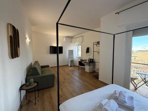 a bedroom with a bed and a living room at Cinquantotto Cozy Rooms in Palermo +50 photos
