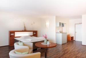 a bedroom with a bed and a table and chairs at Hotel Victoria in Hochheim am Main