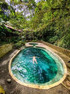 a man is swimming in a swimming pool at Hotel Y Transporte LadyMar in Nuquí
