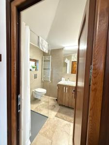 a bathroom with a toilet and a sink at View Cozia in Călimăneşti +19 photos