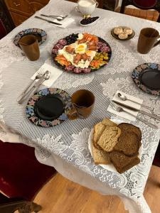 a table with plates of food on a white table cloth at Hotel palas tatarıv in Tatariv +13 photos