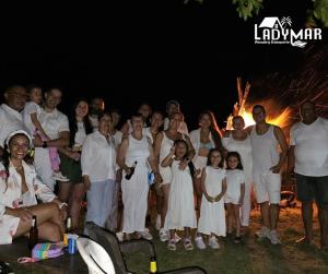 a group of people posing for a picture in front of a fire at Hotel Y Transporte LadyMar in Nuquí