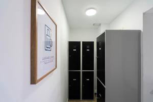 a row of lockers in a room with a mirror at El Mirador Boutique in Alicante