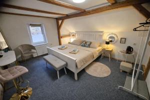 a bedroom with a bed and a table and chairs at hostinec Thérése in Petrovice