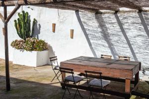 a wooden table and chairs in a patio at La Vaquería in Niebla