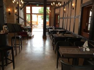 a row of tables and chairs in a restaurant at Apartments anno 1560 in Quedlinburg