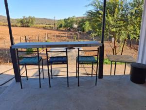 a table and chairs with a view of a field at The STAL in De Rust