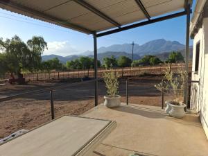 a screened porch with a view of the mountains at The STAL in De Rust +16 photos